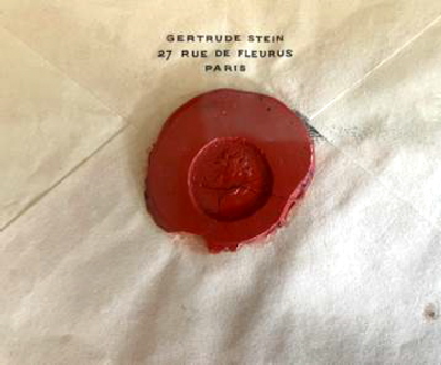 Description: A red wax seal on a white envelope  Description automatically generated