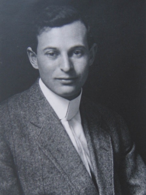 A person in a suit and tie  Description automatically generated